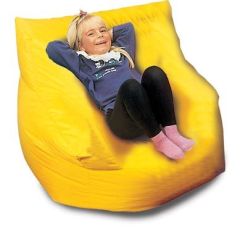 girl sits in a squashy yellow seat